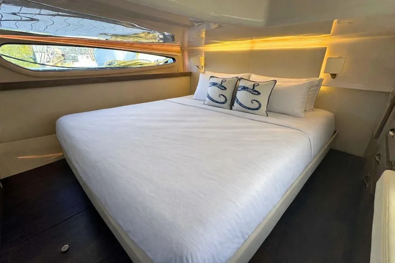  Yacht Photos Pics Luxurious bedroom interior of 2021 Regal 38 Grande Coupe yacht with elegant bedding.