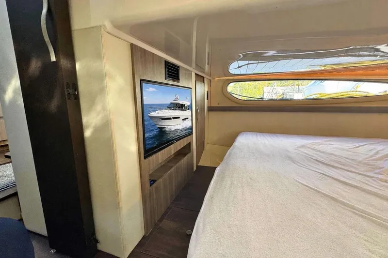  Yacht Photos Pics Interior of 2021 Regal 38 Grande Coupe with bed and wall-mounted TV.