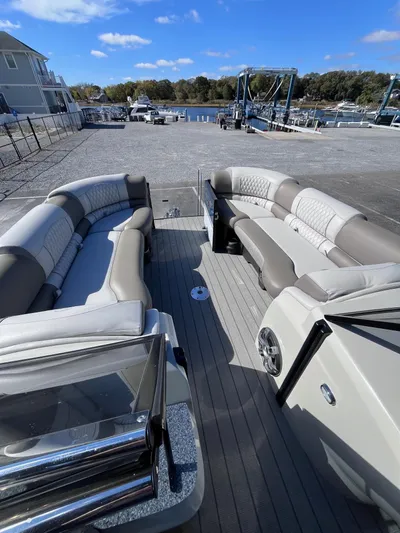  Yacht Photos Pics 2023 Avalon Excalibur Elite Windshield 27' boat with spacious seating at a marina.
