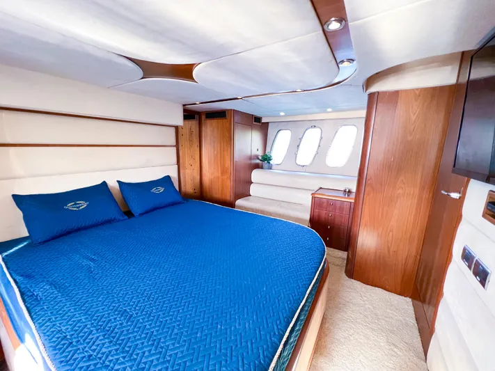  Yacht Photos Pics Luxurious cabin interior of 2005 Sunseeker Predator 68 yacht with blue bedding.