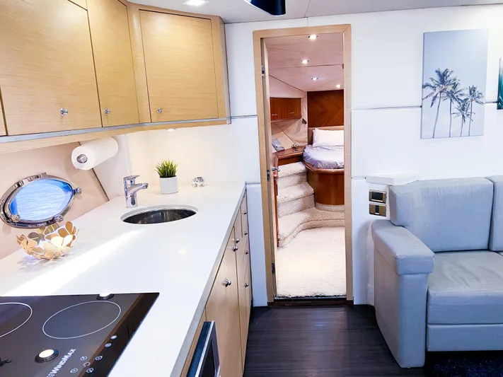  Yacht Photos Pics Interior of 2005 Sunseeker Predator 68 yacht, featuring modern kitchen and cozy living area.