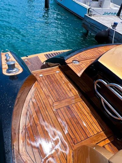  Yacht Photos Pics Sunseeker Predator 68 (2005) yacht with polished wooden deck by the water.