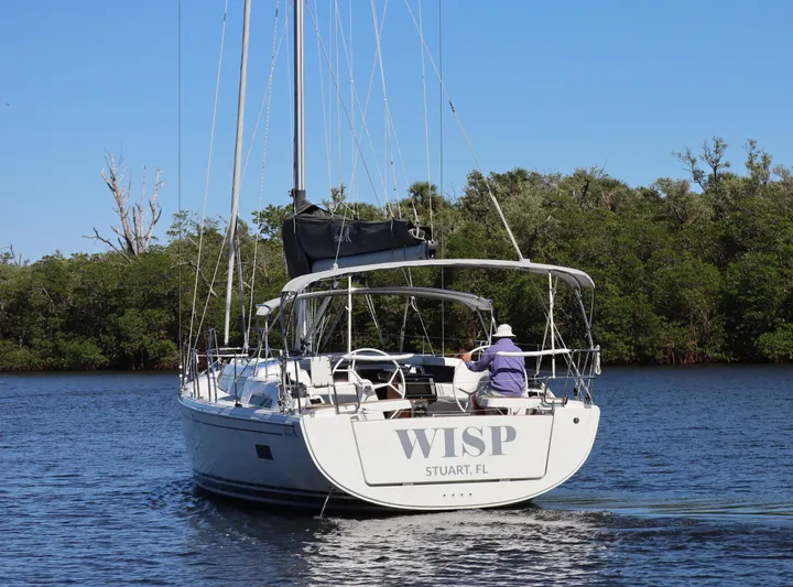 Wisp Yacht Photos Pics Sailing yacht Hanse 388 (2020) on calm water near lush greenery.