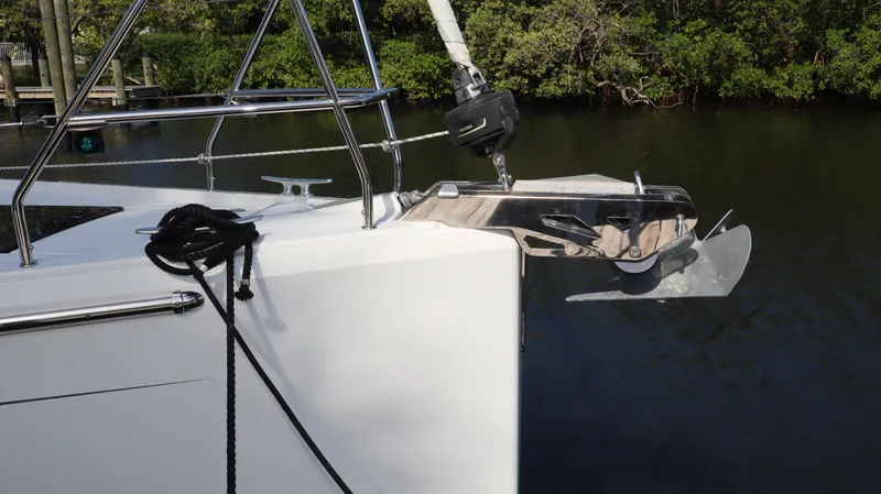 Wisp Yacht Photos Pics Bow of 2020 Hanse 388 yacht with anchor and railing, docked by water.