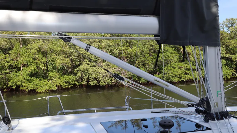 Wisp Yacht Photos Pics Sailing on a 2020 Hanse 388 yacht near lush green shoreline.