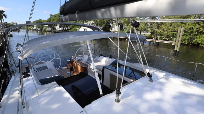 Wisp Yacht Photos Pics 2020 Hanse 388 sailboat docked on a serene river, showcasing its sleek deck design.