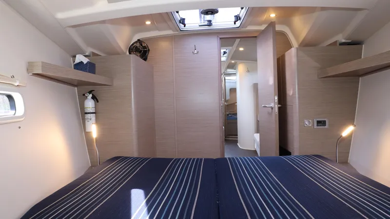 Wisp Yacht Photos Pics Interior of 2020 Hanse 388 yacht cabin with modern design and striped bedding.