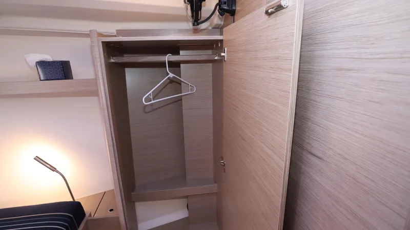 Wisp Yacht Photos Pics Interior of 2020 Hanse 388 yacht showing an open wooden wardrobe with hangers.