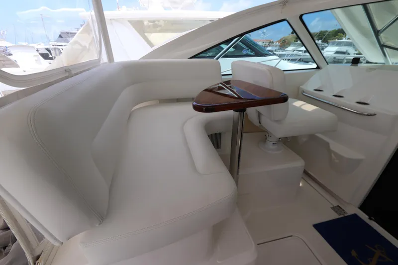 Lady K Yacht Photos Pics Interior of 2020 Tiara Yachts 43 Open, featuring white seating and a wooden table.