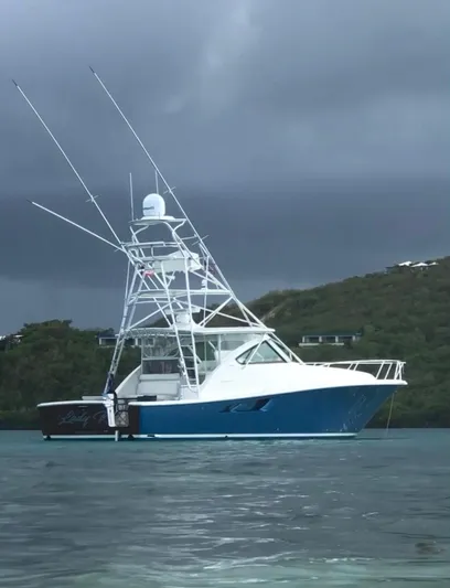 Lady K Yacht Photos Pics 2020 Tiara Yachts 43 Open in serene waters, under a cloudy sky.