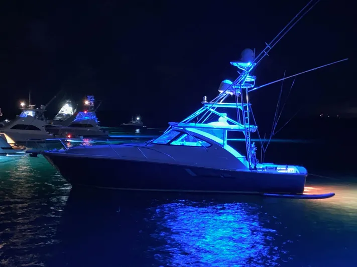 Lady K Yacht Photos Pics 2020 Tiara Yachts 43 Open illuminated at night on the water.
