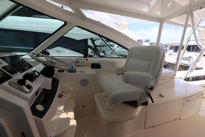 Lady K Yacht Photos Pics 2020 Tiara Yachts 43 Open helm with white captain's chair and steering wheel.