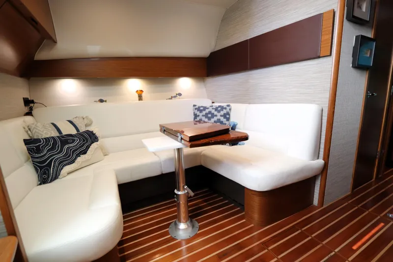 Lady K Yacht Photos Pics Luxurious interior of 2020 Tiara Yachts 43 Open with white seating and wooden accents.