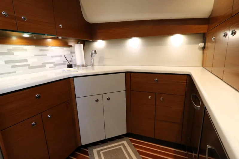 Lady K Yacht Photos Pics Luxurious kitchen interior of 2020 Tiara Yachts 43 Open with modern cabinetry and lighting.