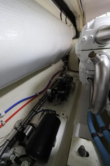 Lady K Yacht Photos Pics Engine room of 2020 Tiara Yachts 43 Open, showcasing pipes and mechanical components.