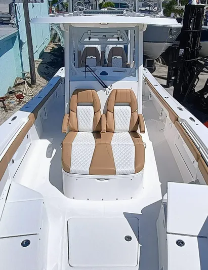 30x0-036 Yacht Photos Pics 2025 Regulator 30XO boat interior with tan and white seating, showcasing modern design.
