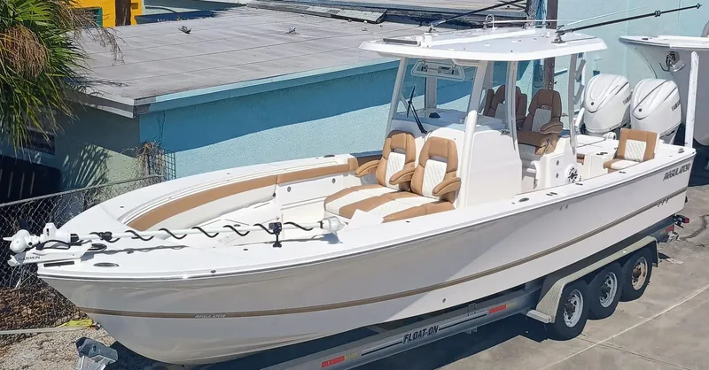  Yacht Photos Pics 2025 Regulator 30XO boat on trailer, featuring dual engines and luxurious seating.