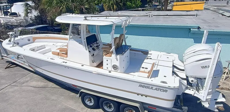  Yacht Photos Pics 2025 Regulator 30XO boat with Yamaha engines on a trailer, parked outdoors.