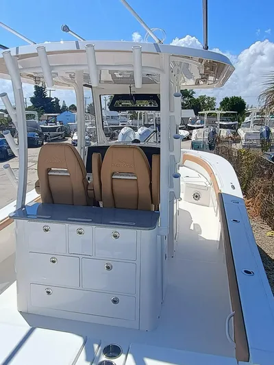 30x0-036 Yacht Photos Pics 2025 Regulator 30XO boat interior with dual seats and storage drawers under a clear blue sky.