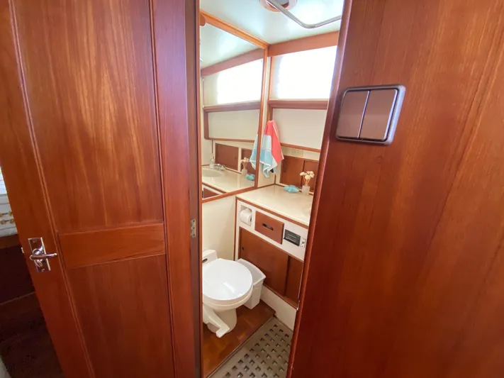 Carpe Diem Yacht Photos Pics 1992 Grand Banks 46 Europa yacht bathroom with wooden cabinetry and modern fixtures.