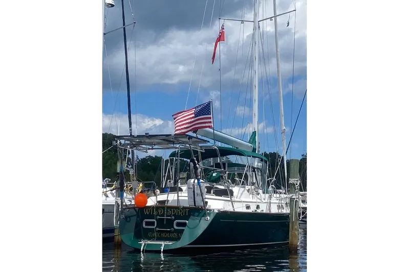 Wild Spirit Yacht Photos Pics Sailboat "Wild Spirit" docked, displaying American flag, under cloudy sky.