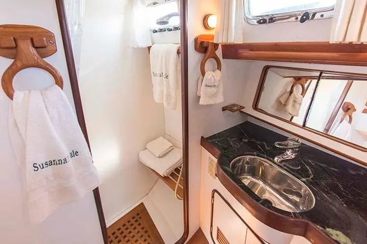 Wild Spirit Yacht Photos Pics Luxurious yacht bathroom with elegant sink, wooden accents, and personalized towels, Passport 456, 1999.