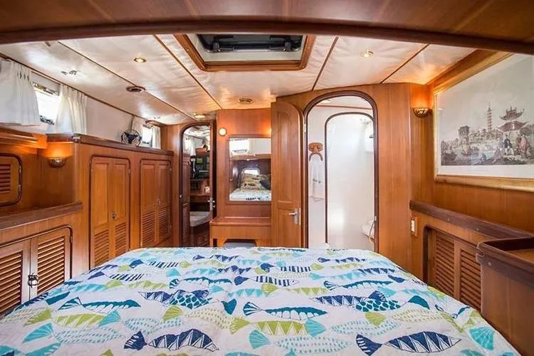 Wild Spirit Yacht Photos Pics Luxurious wooden cabin interior of 1999 Passport 456 yacht with colorful bedding.