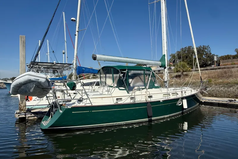 Wild Spirit Yacht Photos Pics Sailboat docked in marina, Passport 456 model, 1999, with green hull and canopy.