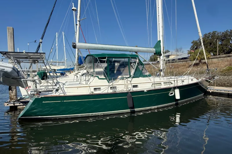 Wild Spirit Yacht Photos Pics Sailboat docked in marina, Passport 456 model, 1999, with green hull and canopy.