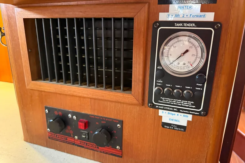 Wild Spirit Yacht Photos Pics Wooden control panel with tank tender gauge and Sea Frost controls, Passport 456, 1999 model.