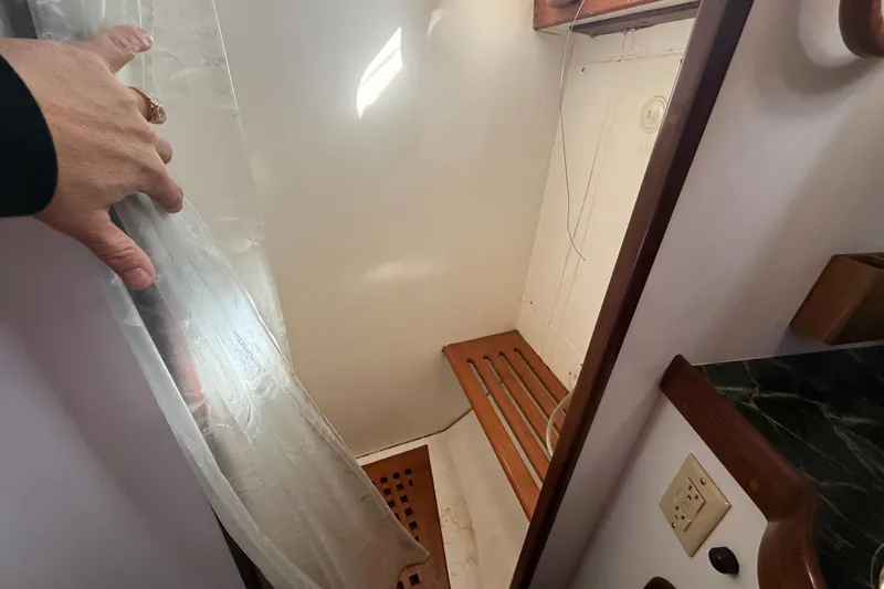 Wild Spirit Yacht Photos Pics Small wooden shower area in a 1999 Passport 456 boat.