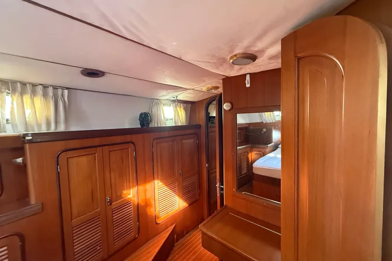 Wild Spirit Yacht Photos Pics Interior of 1999 Passport 456 yacht with wooden cabinetry and cozy sleeping area.