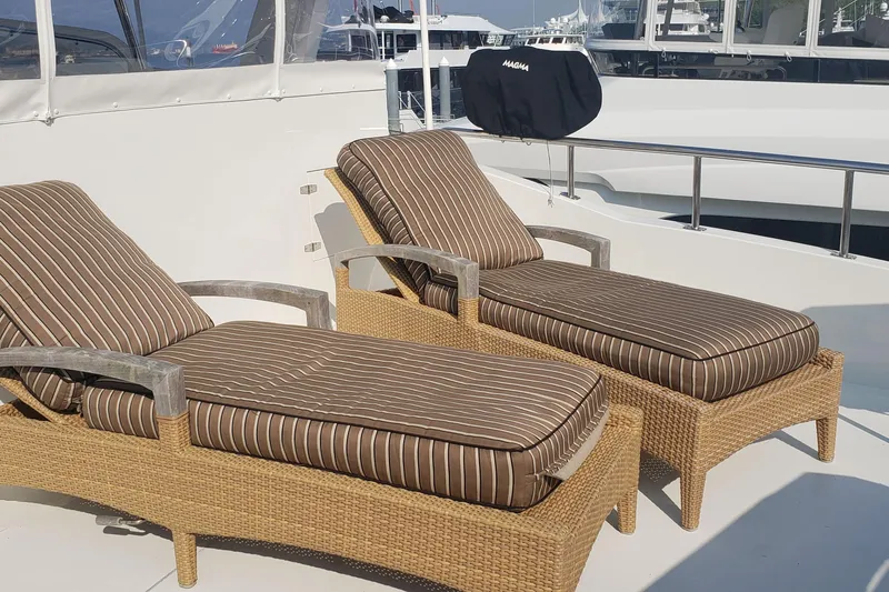 Katula Yacht Photos Pics Two striped lounge chairs on a 2003 Mikelson Long Range Cockpit MY yacht deck.