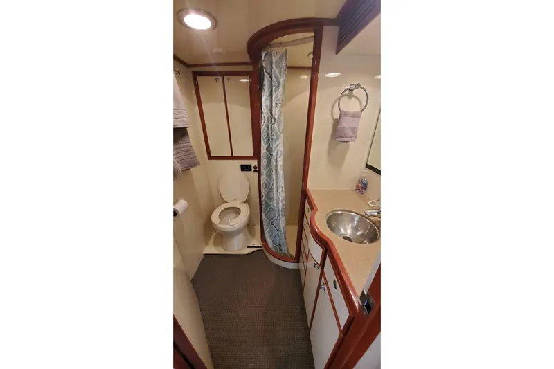 Katula Yacht Photos Pics Bathroom interior of 2003 Mikelson Long Range Cockpit MY yacht, featuring shower and sink.