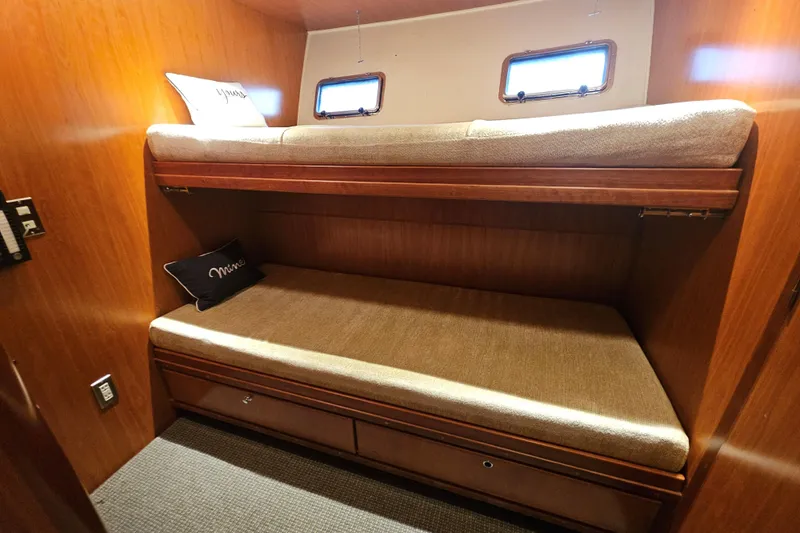 Katula Yacht Photos Pics 2003 Mikelson Long Range Cockpit MY cabin with wooden bunk beds and small windows.