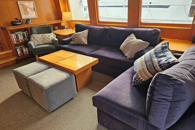 Katula Yacht Photos Pics Luxurious 2003 Mikelson yacht interior with plush seating, wooden accents, and decorative pillows.