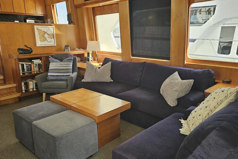 Katula Yacht Photos Pics Luxurious 2003 Mikelson yacht interior with cozy seating, wooden accents, and large windows.