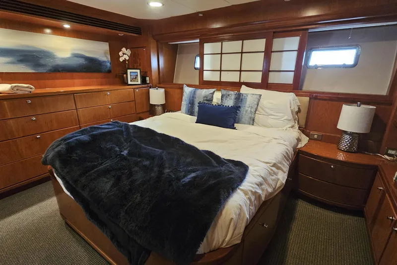 Katula Yacht Photos Pics Luxurious bedroom interior of 2003 Mikelson Long Range Cockpit MY yacht with elegant wood finish.