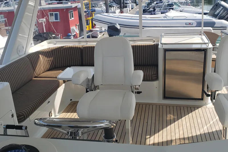 Katula Yacht Photos Pics Luxurious 2003 Mikelson Long Range Cockpit MY yacht interior with seating and helm.