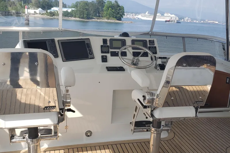 Katula Yacht Photos Pics Cockpit of 2003 Mikelson Long Range yacht with steering wheel and navigation equipment.