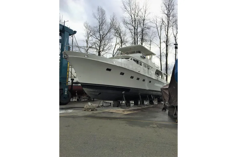Katula Yacht Photos Pics 2003 Mikelson Long Range Cockpit MY yacht on dry dock, surrounded by trees.