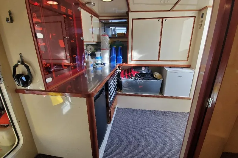 Katula Yacht Photos Pics 2003 Mikelson Long Range Cockpit MY interior with storage, mini fridge, and counter space.