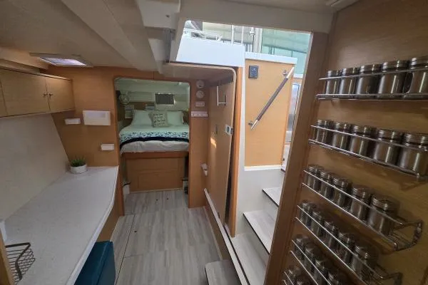 Tetelestai Yacht Photos Pics Interior of 2011 Lagoon 400 catamaran with modern kitchen and cozy bedroom.