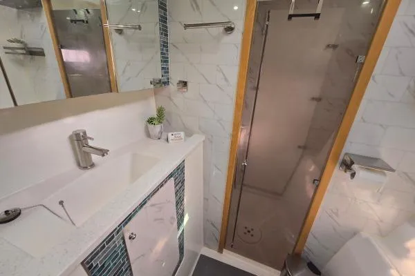 Tetelestai Yacht Photos Pics Modern bathroom in 2011 Lagoon 400 yacht with sleek shower and stylish sink area.