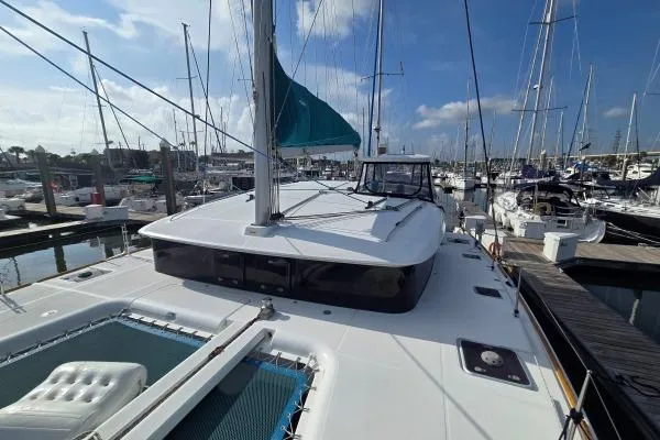 Tetelestai Yacht Photos Pics 2011 Lagoon 400 catamaran docked at marina under clear blue sky.
