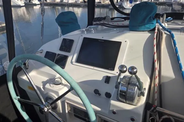 Tetelestai Yacht Photos Pics Helm of 2011 Lagoon 400 catamaran with steering wheel and navigation controls.