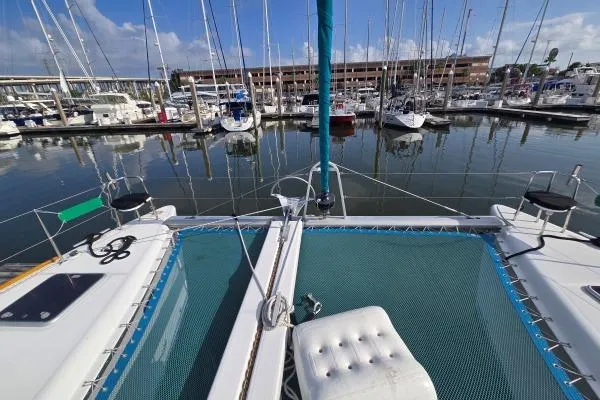 Tetelestai Yacht Photos Pics Catamaran Lagoon 400, 2011 model, docked in a marina with multiple sailboats.