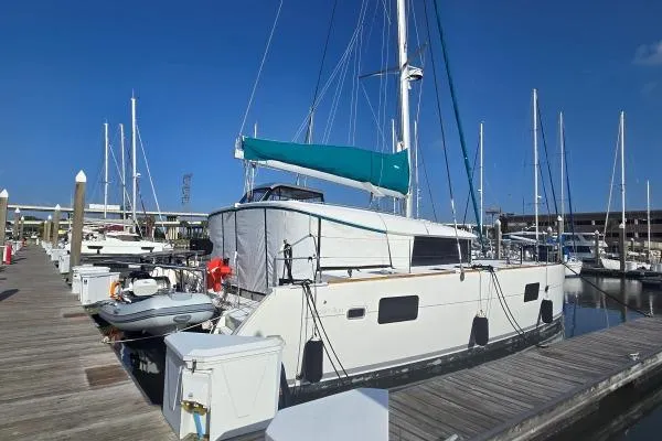 Tetelestai Yacht Photos Pics 2011 Lagoon 400 catamaran docked at a marina under clear blue skies.