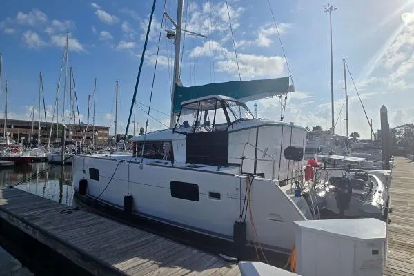 Tetelestai Yacht Photos Pics 2011 Lagoon 400 catamaran docked at marina under clear blue sky.