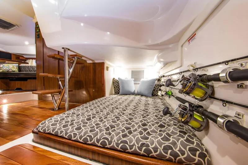  Yacht Photos Pics Manufacturer Provided Image: 2017 Pursuit OS 355 Offshore cabin interior with bed and fishing rods.